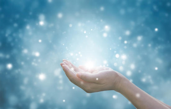 Hands of a woman respecting and praying on blue particle background